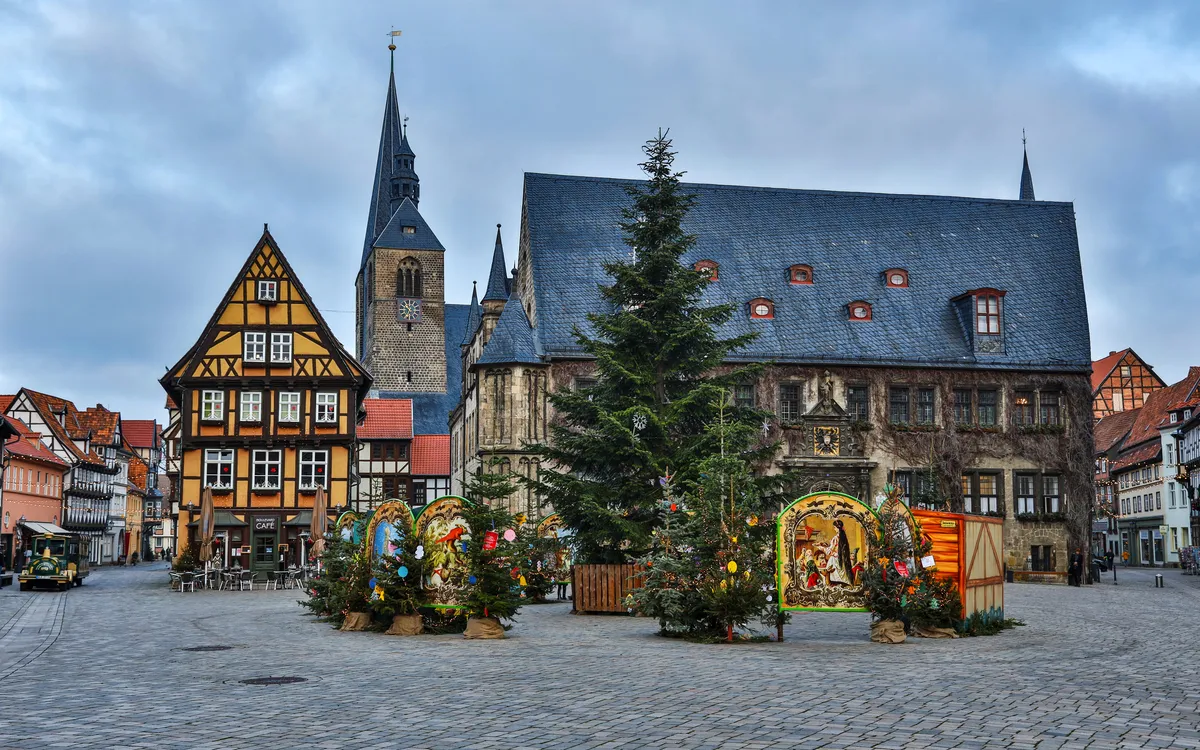 Städtischer Platz mit Fachwerkhäusern und Weihnachtsdekorationen.