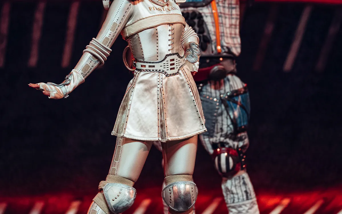 Zwei Darsteller in futuristischen Kostümen mit Rollschuhen auf der Bühne.